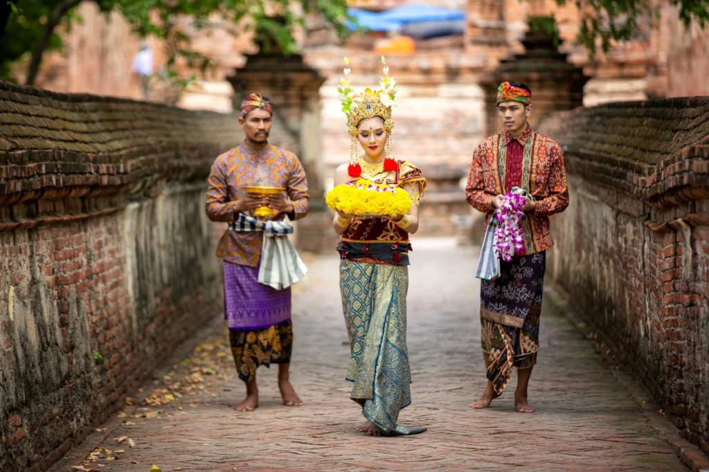 natives in traditional indonesian clothing at bali