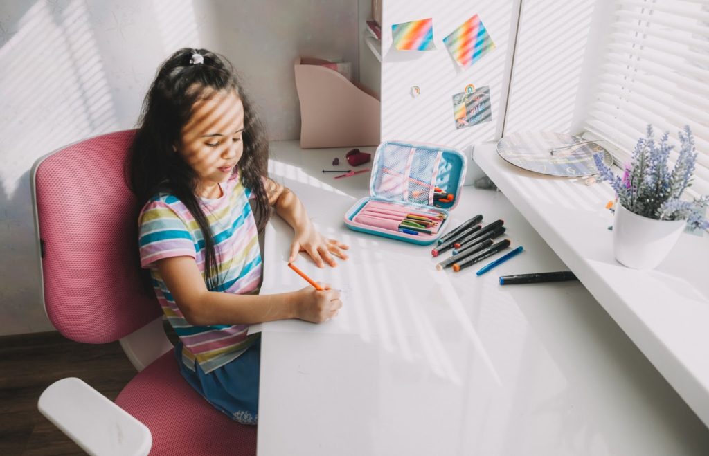 a toddler drawing on a piece of paper