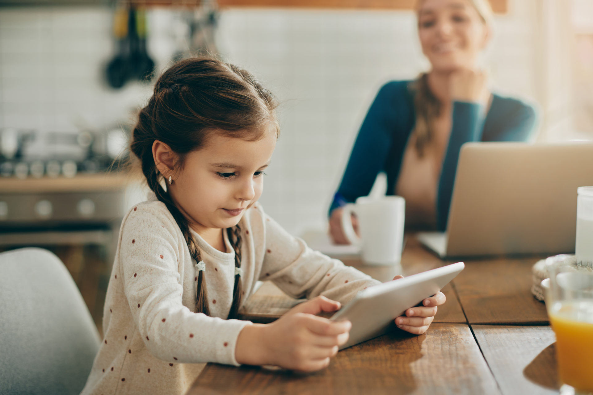 Cute small girl using digital table while relaxing at home. screen time parental control for kids